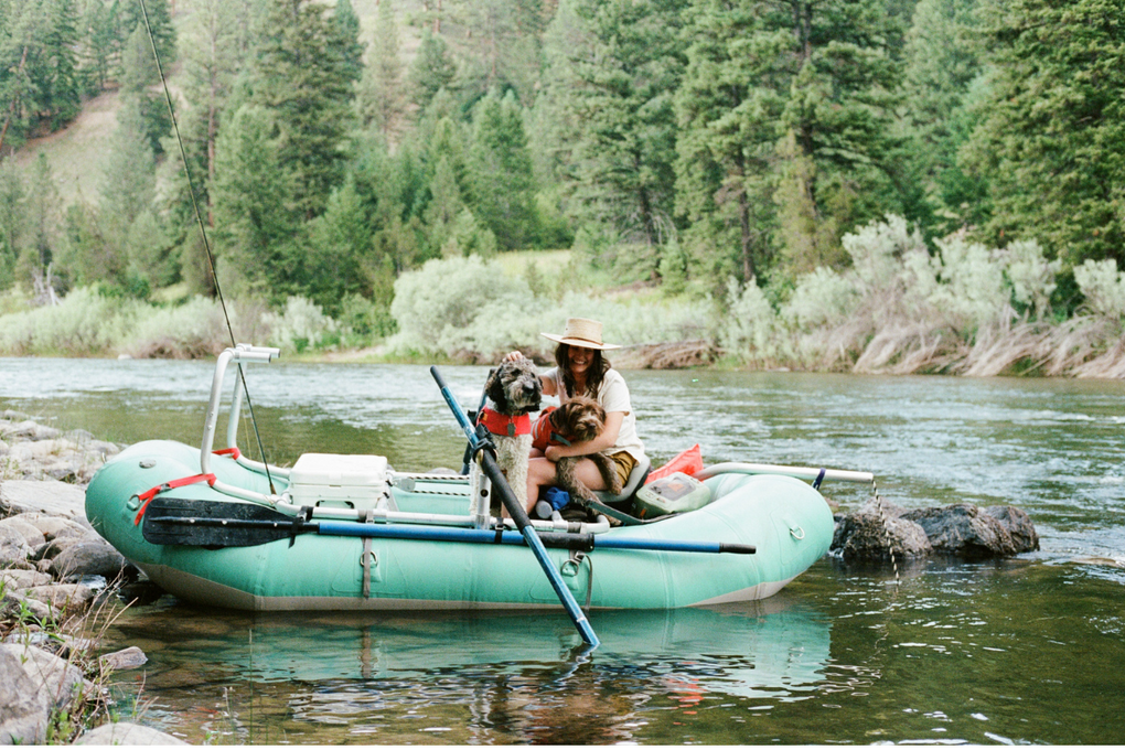 Gloria and her two dogs on a raft.